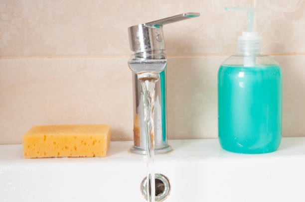 Faucet with flowing water in a bathroom