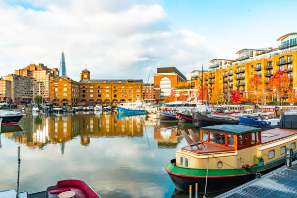 Crowds of people enjoying al fresco cafes, restaurants and bars on St. Katharine Dock in the heart of London.