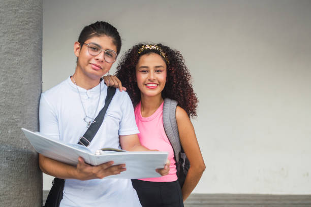 istock Latin american students smiling and studying together at school 2189039956