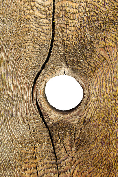 Old wooden surface with a hole in the middle for background or texture.