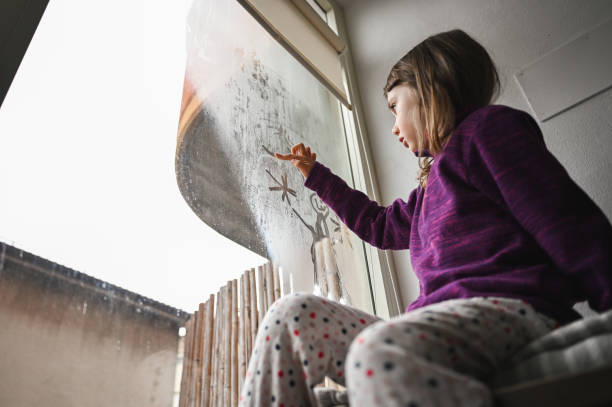 istock drawing on condensed window at home. 2189043447