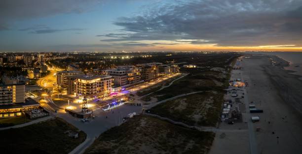 istock Coastal cityscape at dusk with illuminated buildings. 2189043775