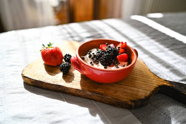 greek yogurt with fruits on bed.