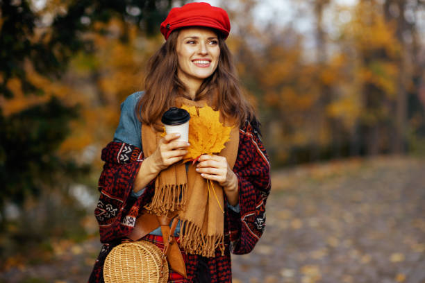 istock happy elegant 40 years old woman in red hat walking 2189045103