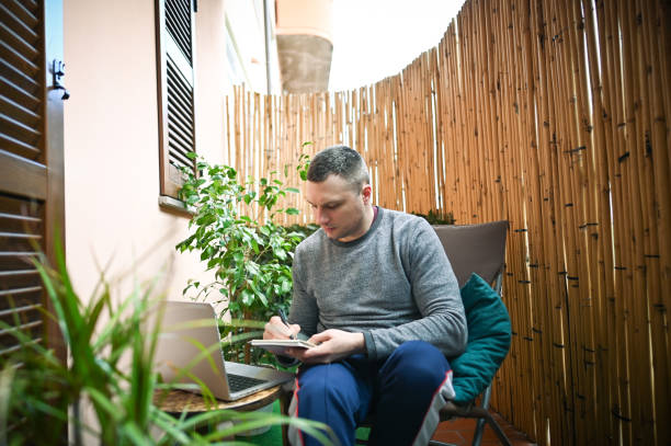 istock Mid adult man working on laptop. 2189045417