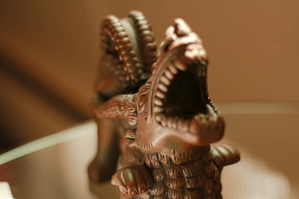 istock Ceramic Incense Dragon with on a Glass Table 2189045520