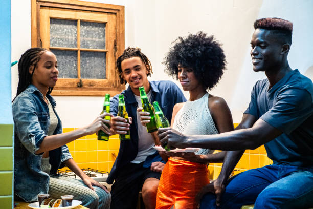 istock Young friends talking and drinking beer at home 2189049069