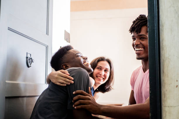 istock Young man greeting friends at home 2189049386