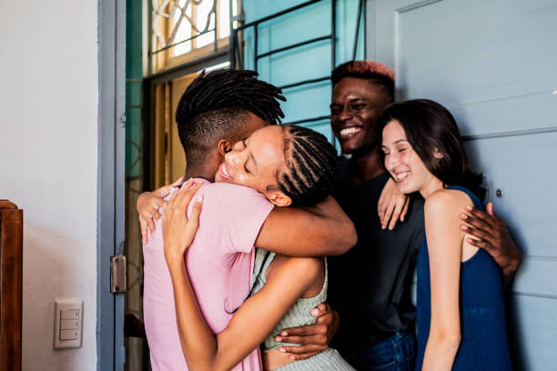 istock Young friends talking and embracing at home 2189049428