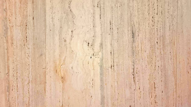 a warm, textured travertine stone wall with a beige background, ideal for creating a classic and elegant ambiance in interior design projects.