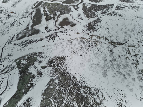 istock Small river flowing through snowy landscape in winter 2189051812