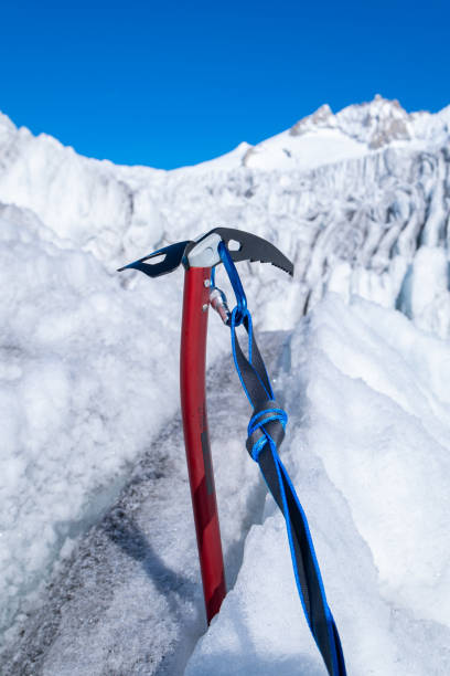 ice axe in ice with carabiner and sling