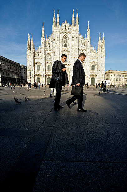 Milan, Lombardy, Italy, Europe - May 20, 2014: Businessmen in Piazza Duomo, with the Milan Cathedral in the background