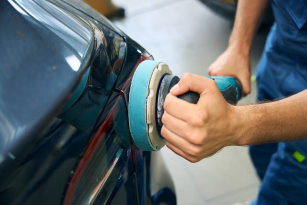 istock Close up of man working in a garage while polishing a car 2189056071