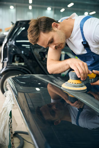 istock Man doing a car polish with a machine in service station shop 2189056151