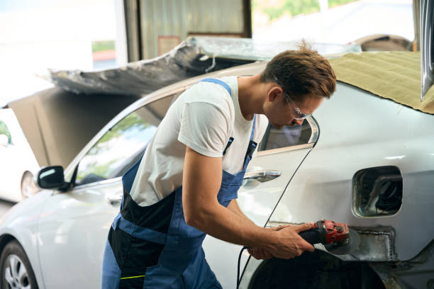istock Mechanic working with angle grinder to fix metal body in garage 2189056208