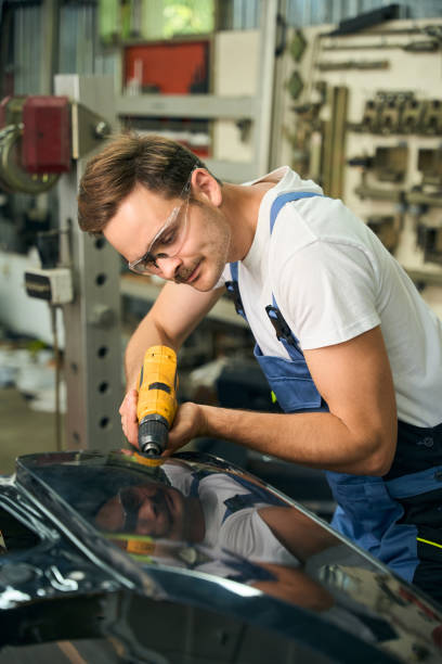 istock Car mechanic working on a vehicle part in auto workshop 2189056213