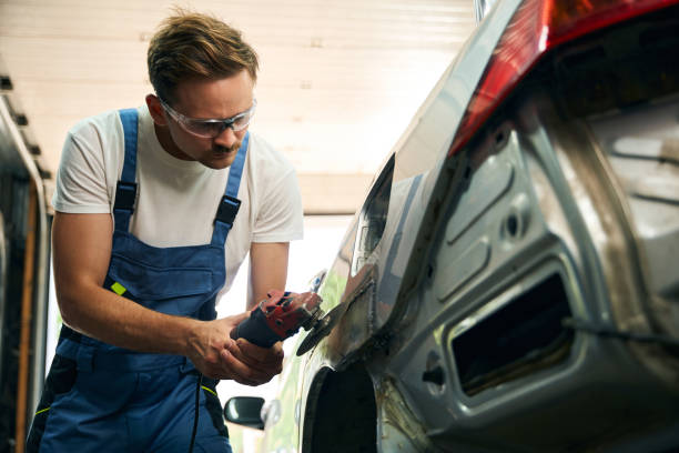 Mechanic polish surface of auto, prepare for repair stock photo