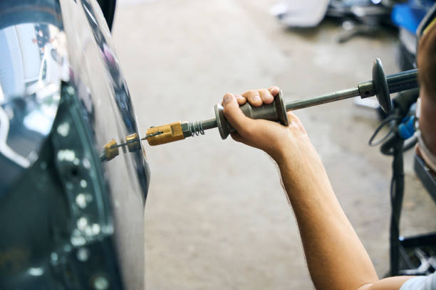 istock Repair service worker fix damaged car 2189056239
