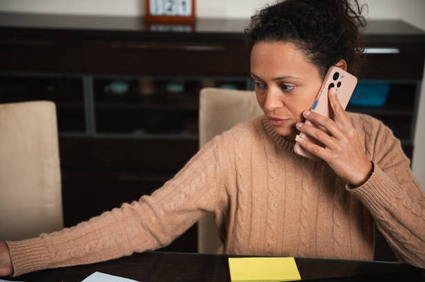 istock Woman engaged in conversation while working at home office desk 2189061971