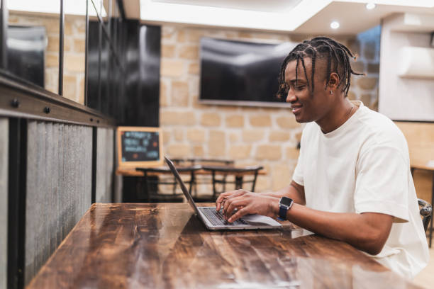 istock Young freelancer working on laptop in cozy cafe. 2189062230