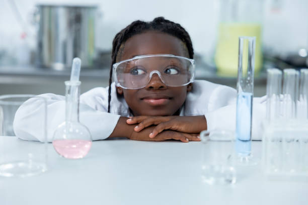 istock Female chemist in lab testing liquid in flask and tube conducting scientific experiments 2189063273