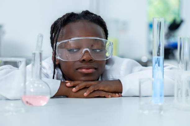istock Female chemist in lab testing liquid in flask and tube conducting scientific experiments 2189063292