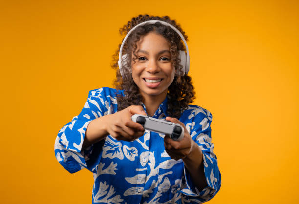 istock Young african woman playing and win online video game on console with joystick 2189064098