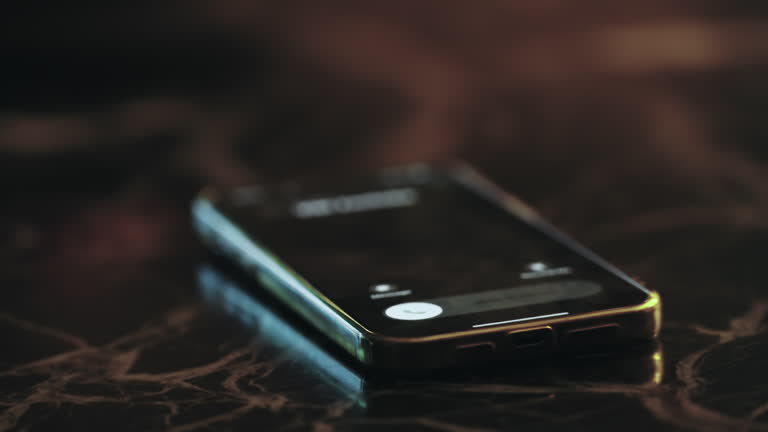 A cell phone ringing on call aslaying on a table