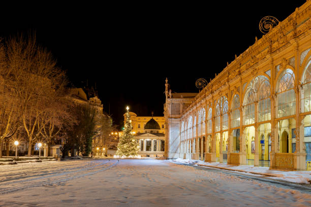 Marianske Lazne, Czech Republic - January 20, 2021: Snow winter in Czech spa town Marianske Lazne (Marienbad) - Main colonnade and white pavilion with Christmas tree - Czech Republic