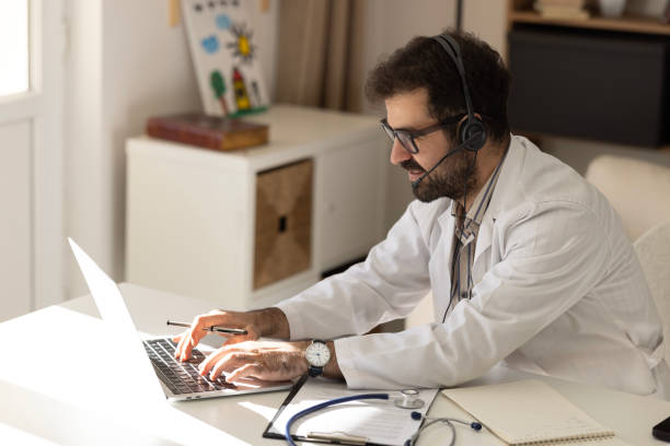 istock Doctor speaks with patient using laptop online 2189065134
