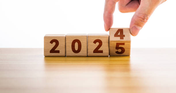 istock Hand flipping block 2024 to 2025 on table 2189067596