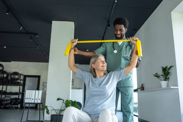 istock Man physiotherapist exercising with patient in therapy session for physical recovery after trauma 2189067773