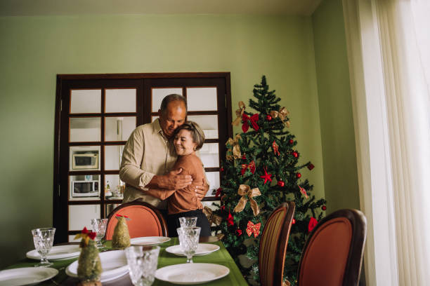 istock Senior couple hugging in the dining room 2189067838