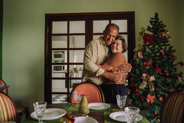Senior couple hugging in the dining room