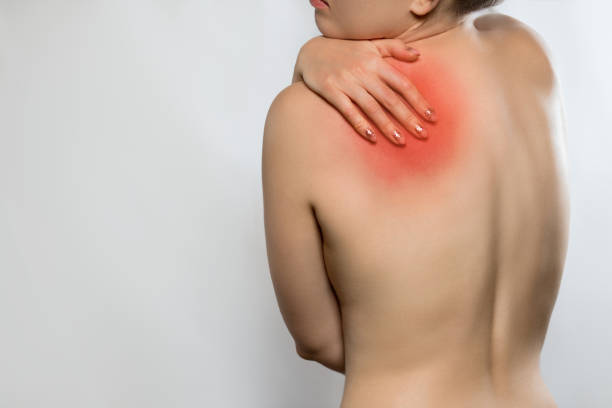 istock Woman touching her back. Female having backache, pain back isolated on gray background. Scoliosis. Spinal cord problems on womans back. 2189069130