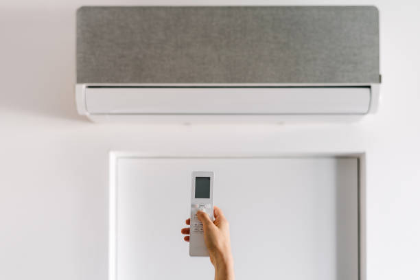 istock Sleek wall-mounted AC unit with remote for ideal climate comfort 2189069390