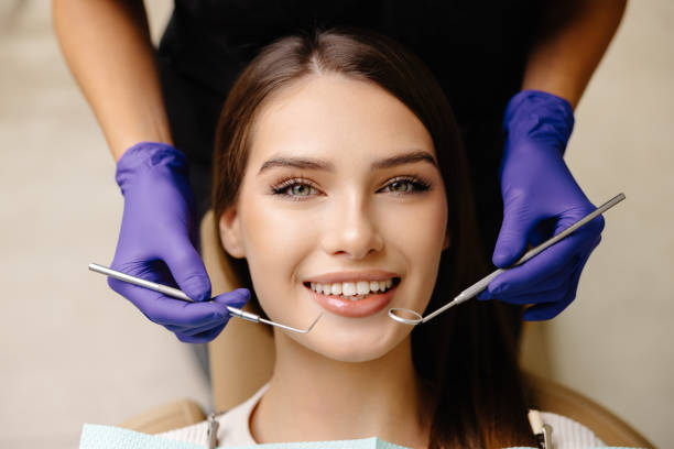 istock Happy patient during a visit to the dentist. The doctor is checking teeth using a dental instrument, ensuring proper oral care in the dentistry clinic 2189069563