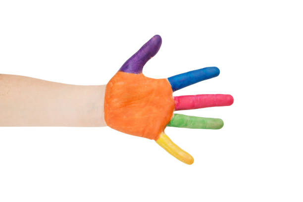 Child's hand painted with multicolored finger paints on white background