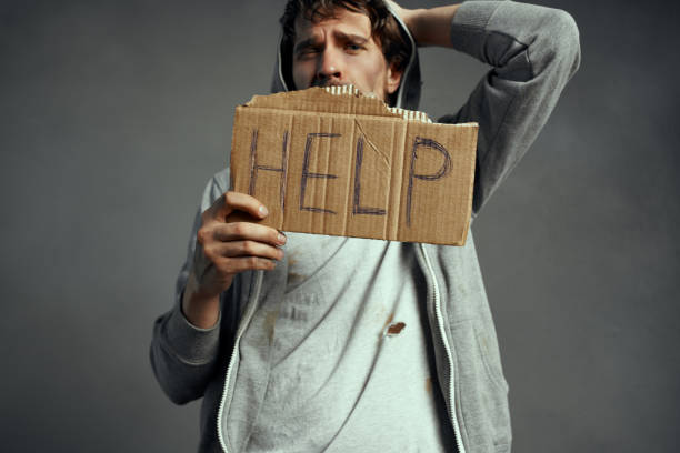 istock poor tramp holding a sign Help emotion loneliness on the street 2189069985