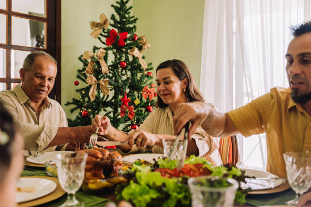 istock Latin family sitting at the table, celebrating Christmas, having dinner 2189071054