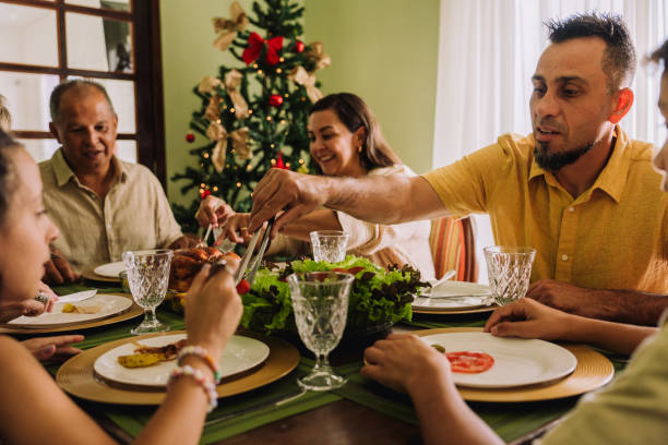 istock Latin family sitting at the table, celebrating Christmas, having dinner 2189071076