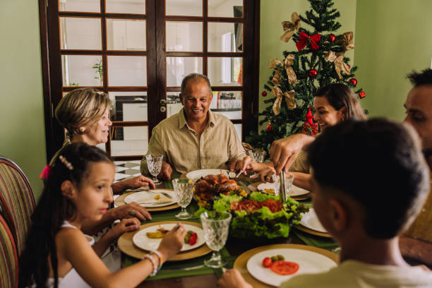 istock Latin family sitting at the table, celebrating Christmas, having dinner 2189071077