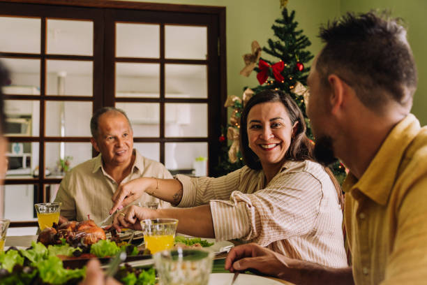 istock Latin family sitting at the table, celebrating Christmas, having dinner 2189071116