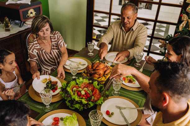 istock Latin family sitting at the table, celebrating Christmas, having dinner 2189071117