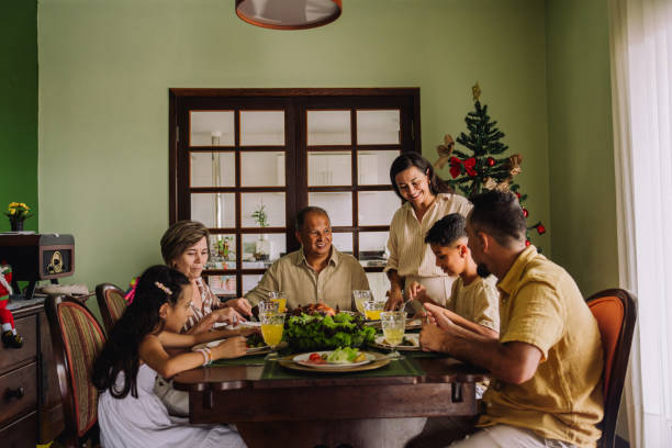istock Latin family sitting at the table, celebrating Christmas, having dinner 2189071120