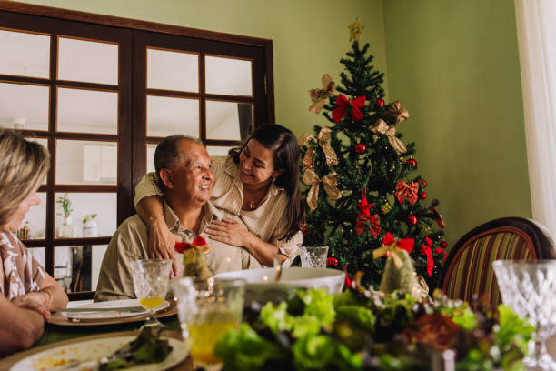 istock Daughter hugging elderly father, celebrating Christmas, 2189071517