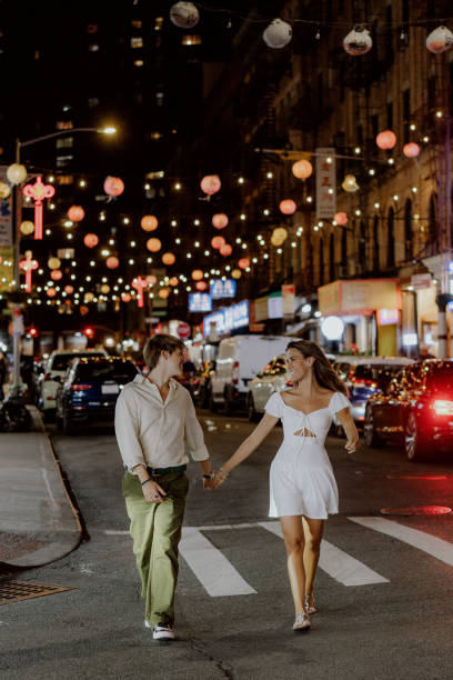 istock Charming couple strolling under festive city lights, fully embracing their special moment 2189072990