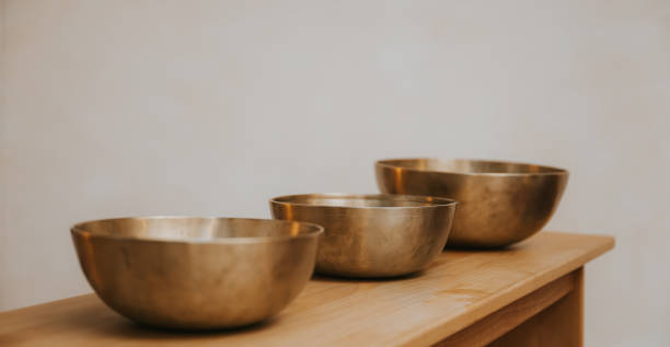 istock three singing bowls on a simple wooden bench 2189073036