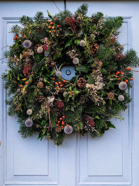 istock Christmas wreath on a light grey blue wooden door 2189074305